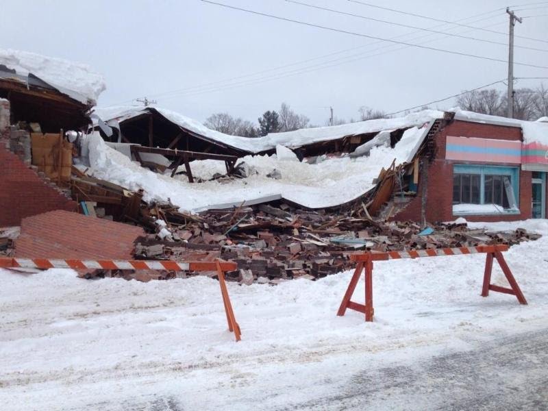 A building that has been damaged by a snow storm.